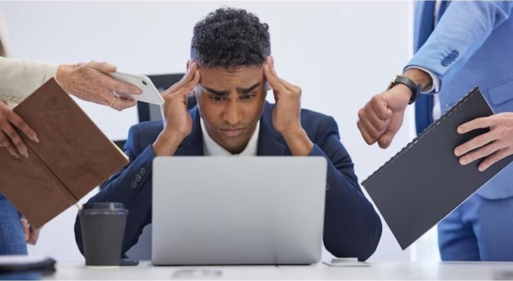 Frustrated business owner at desk surrounded by legal paperwork, court documents, and multiple court dates