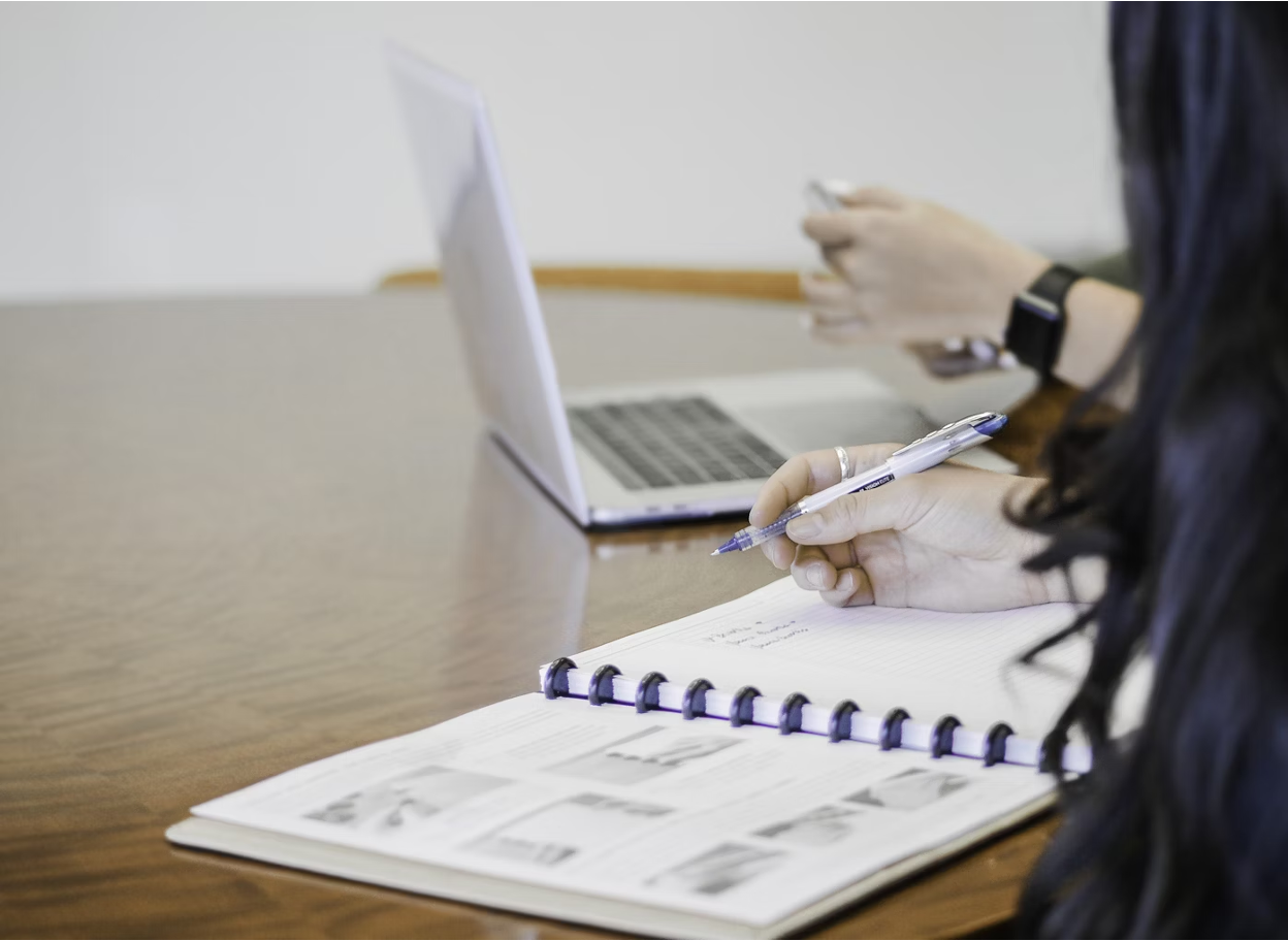 Professional on laptop with financial documents