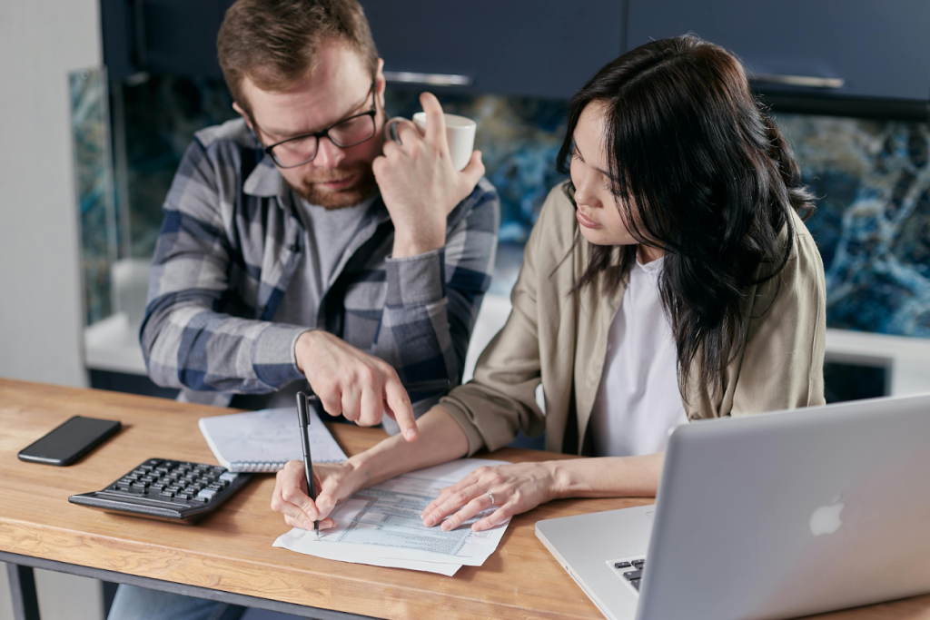 Two business professionals reviewing financial documents
