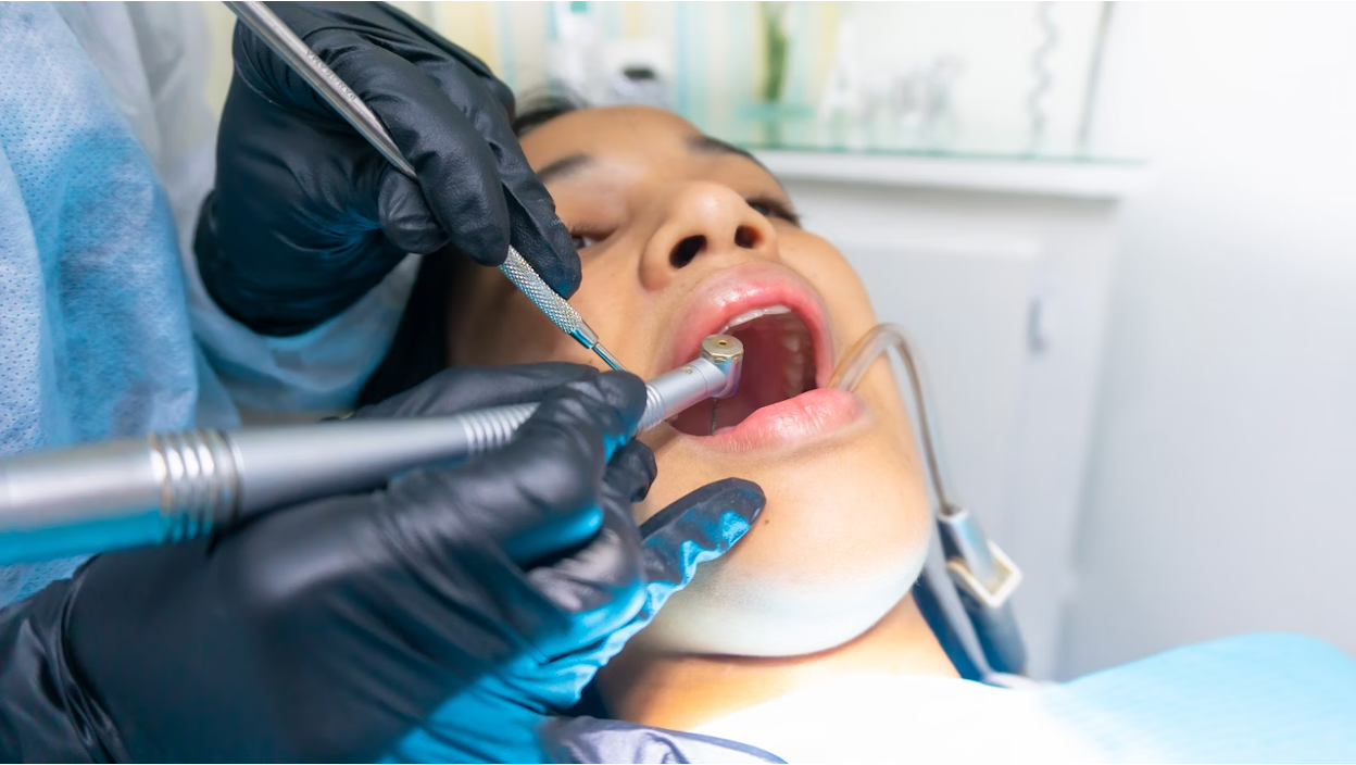 A dentist examining a patient's teeth