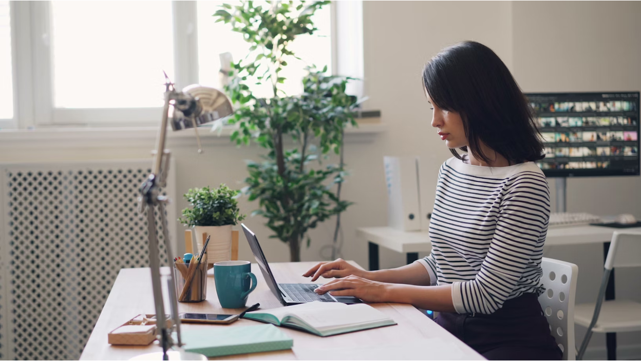 Business professional reviewing financial documents while analyzing debt collection
