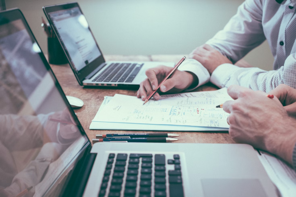 Collection agency professionals reviewing account files and documents in a modern office setting