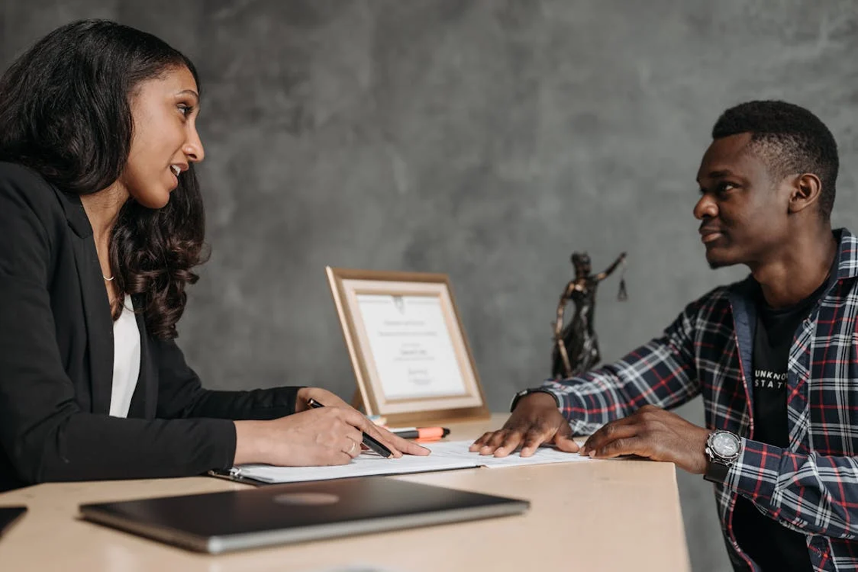 Professionals having a conversation and reviewing documents