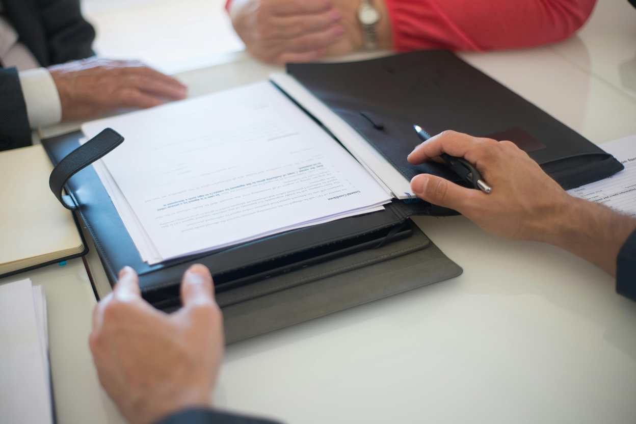 Professionals reviewing documents during a meeting