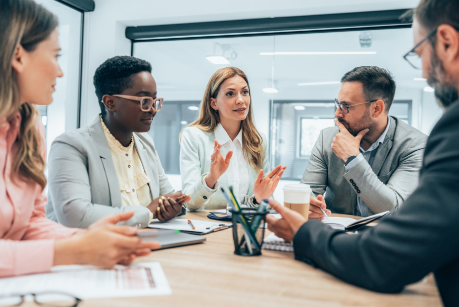 Business meeting with five professionals around a conference table.