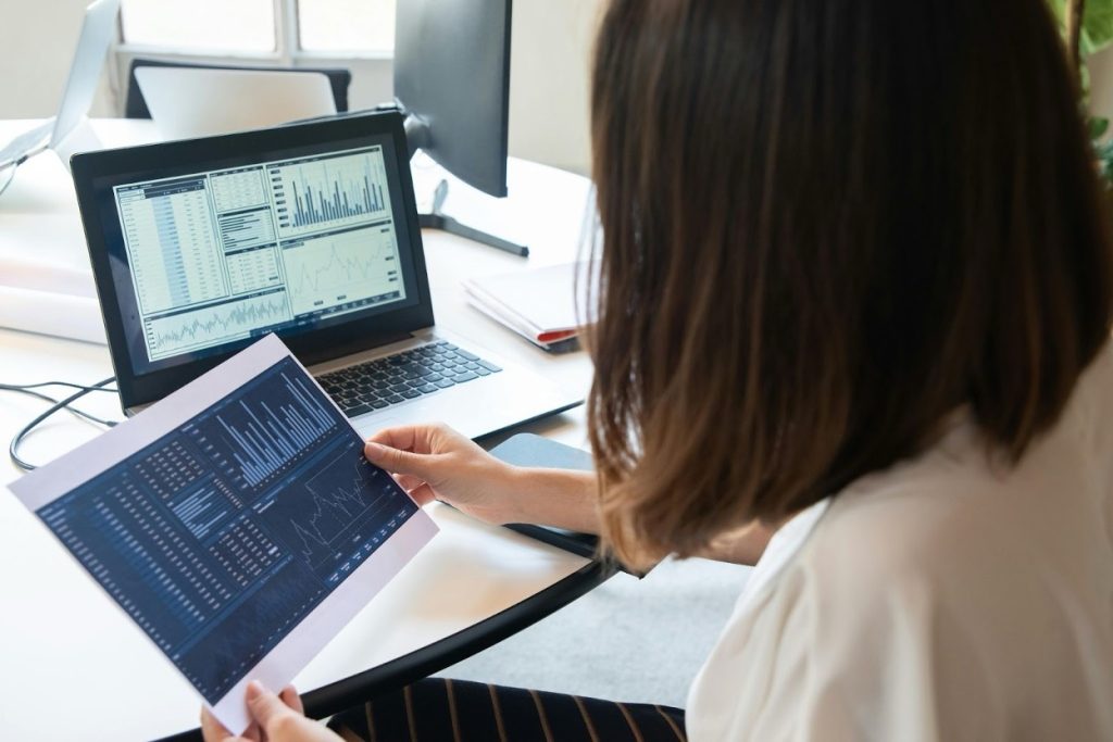 Business person analyzing financial charts