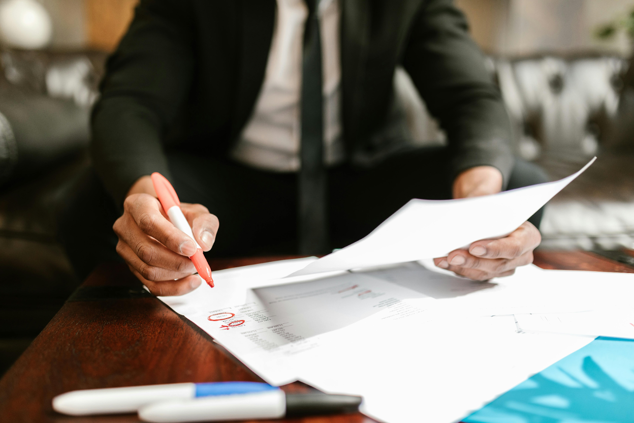Business professional analyzing financial documents at a desk