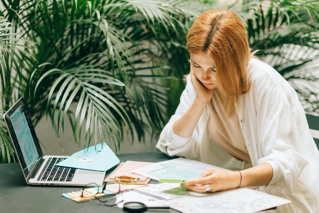 Small business owner reviewing credit policy documents and payment terms
