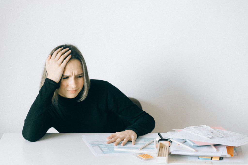 Woman reviewing bills and documents at a table