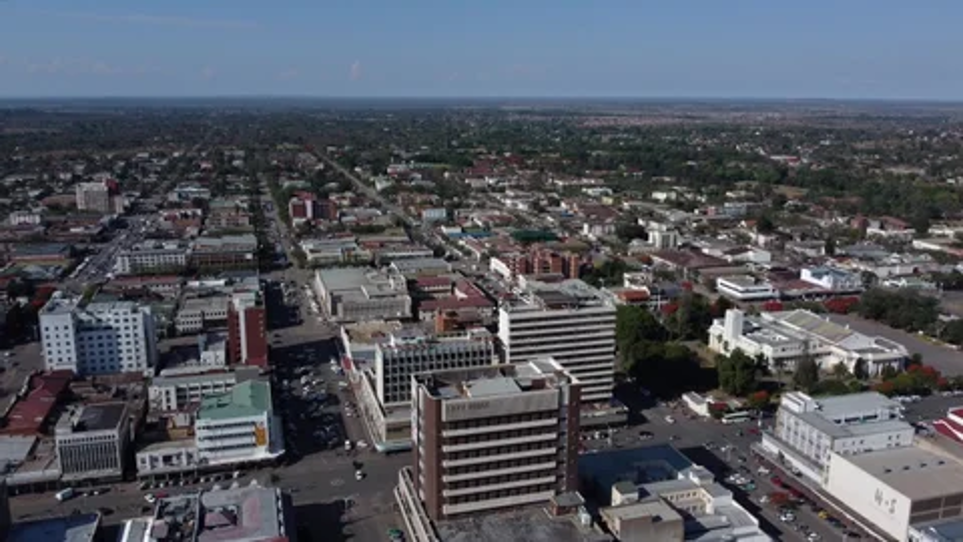 Aerial view of a city's downtown area with commercial buildings and streets extending toward the horizon
