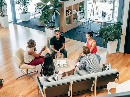 Business professionals in a meeting discussing debt collection strategies, accounts receivable, and agency selection criteria.