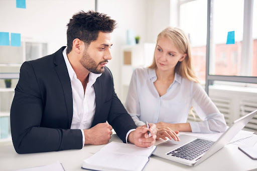 Business professionals reviewing collection agency pricing proposals and contract terms.
