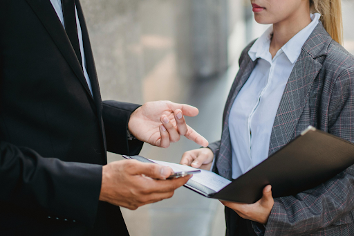 Two business professionals standing in front of each other.